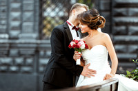 Bride and bridegroom standing with bouquet and embracing