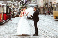 Bride and bridegroom walking across the street