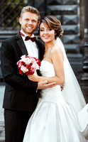 Bride and bridegroom holding bouquet and smiling
